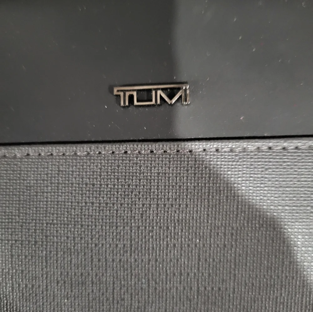 TUMI FOR DELTA ZIPPER TOILETRIES CASE IN TWO TONE GRAY WITH SILVER LOGO